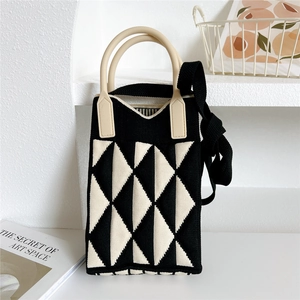 Macro detail of geometric knitted texture and soft silicone handle on the mini crossbody bag