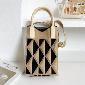 Detail of a mini knitted handbag with khaki and black triangle pattern and soft silicone handle