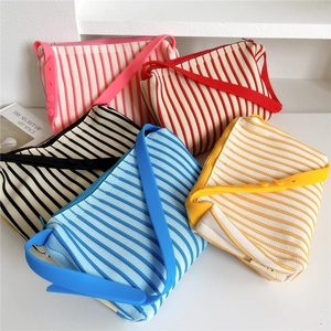 Striped knit shoulder bags with adjustable silicone straps in five vibrant colors