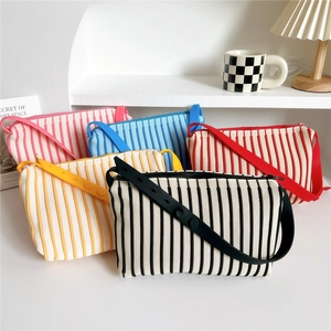 Detailed display of colorful striped knit tote bags with adjustable wide shoulder straps