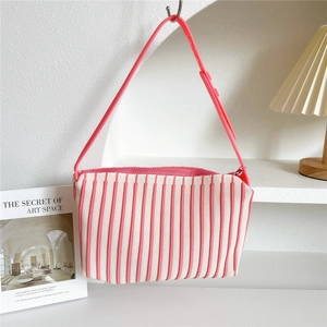 Detailed knit texture and adjustable strap of striped pink shoulder bag for women