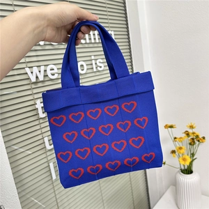 Royal blue knitted tote bag with red heart patterns and magnetic closure