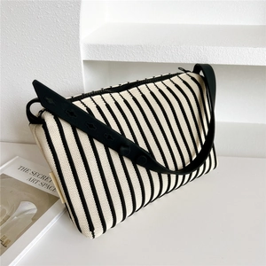 Close-up of the vertical black and white striped texture on this knitted shoulder bag