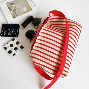 Striped knit handbag with red silicone shoulder strap and zipper closure for women