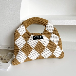 Detail of knitted tote bag showing brown and white checkered pattern and brand label