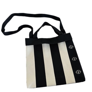 Minimalist black and white striped knit tote bag with shoulder strap and embroidery
