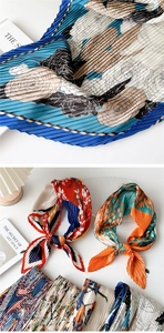 Detail of pleated silk scarf showing tight micro-folds and vintage floral patterns