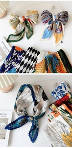 Detail of pleated silk scarves featuring various prints like floral and paisley patterns