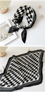 Detailed view of black and white checkerboard pleated scarf with fine edge crimping texture