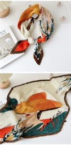 Detail of pleated silk scarf showing vintage french illustration and fine texture
