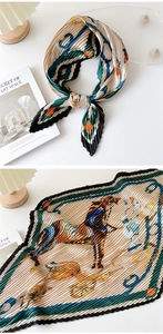 Detail of pleated silk scarf featuring classic horse carriage print and accordion folds