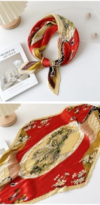 Close-up of pleated silk scarf with vintage floral patterns in red and yellow tones