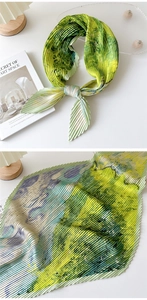 Detailed view of pleated silk scarf with abstract oil painting print and textured fabric