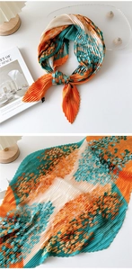Detail view of colorful pleated square scarf with floral print and accordion texture