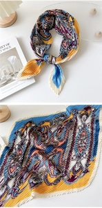 Detail of pleated paisley scarf with vibrant floral patterns used as a stylish hair accessory