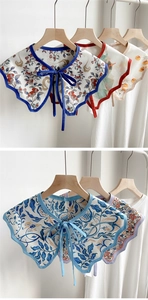 Detail of printed decorative shawl collars featuring vintage patterns and wave edges