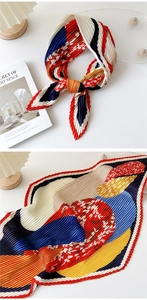 Detail view of multi-color pleated silk scarf with abstract geometric patterns