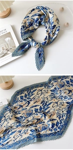 Detail of pleated silk scarf featuring vintage floral print and fine mechanical accordion folds