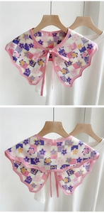 Detailed view of floral checkerboard fake collar with wavy edges and pink ribbon tie