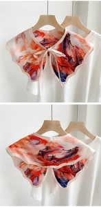 Detail of scalloped edge shawl scarf with dragon print and pink ribbon tie closure