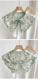 Detail of floral detachable fake collar with bow tie design and green piping finish