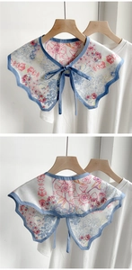 Detail of floral chiffon shawl collar showing wavy blue edges and bow tie on white shirt