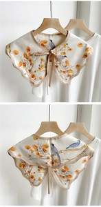 Detail of silk-like decorative collar with autumn bird and leaf print on a hanger