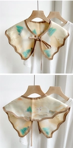 Detail of vintage Chinese landscape print shawl collar with silk texture and ribbon tie