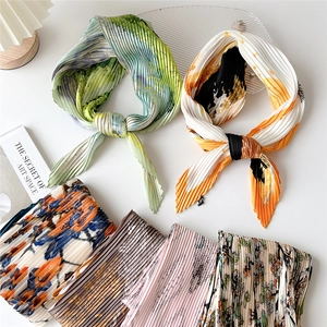 Pleated square scarf collection with floral prints and accordion folds on white background