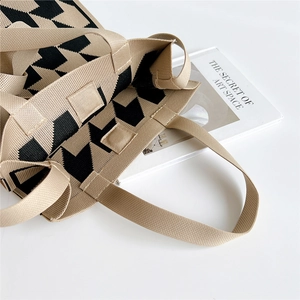 Knitted tote bag with houndstooth pattern and magnetic buckle closure on white background