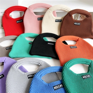 Colorful knitted dumpling tote bags with woven HILLDI label in multiple vibrant colors