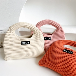 Minimalist knitted tote bags in beige, pink, and orange with brand label detail