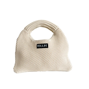 Beige chunky knit dumpling handbag featuring a textured honeycomb pattern and soft handles