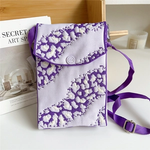 Detail of purple knit leopard pattern phone bag with round button and adjustable strap