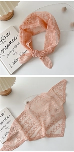 Gros plan d'un foulard triangle en dentelle rose avec des motifs floraux délicats