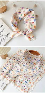Detail of floral and rainbow printed cotton linen scarf showing soft sheer texture