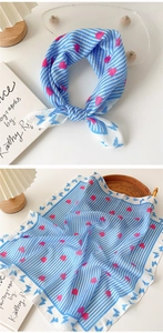 Detail of cotton linen scarf featuring blue stripes, pink hearts, and butterfly patterns