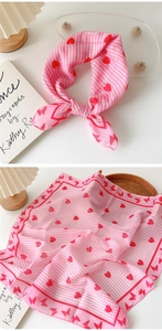 Detail of pink cotton linen scarf with red hearts and butterflies in a lifestyle setting
