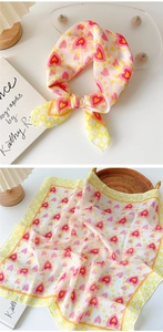 Detailed view of floral cotton linen scarf with red hearts and yellow checkered border