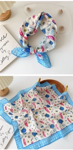 Detail of blue polka dot cotton linen scarf with pink lucky lettering and artistic graphics
