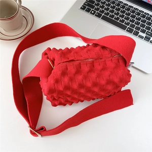 Detail of red bubble texture fabric bag with wide shoulder strap in life scene