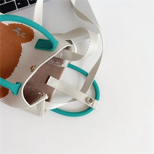 Detail of knitted tote bag with brown bear pattern and mint green silicone ring handle
