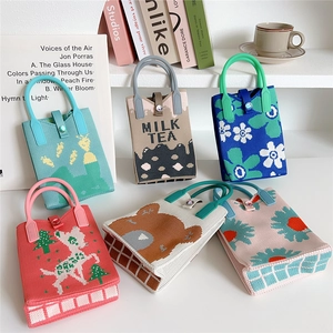 Variety of mini knitted handbag phone pouches with cartoon patterns and handle