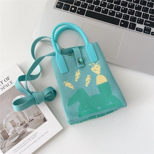 Close-up of mint green knitted handbag with animal pattern and adjustable shoulder strap