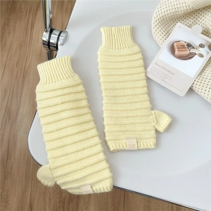 Detaillierte Strickstruktur der hellgelben fingerlosen Handschuhe mit Jennie Wool Label