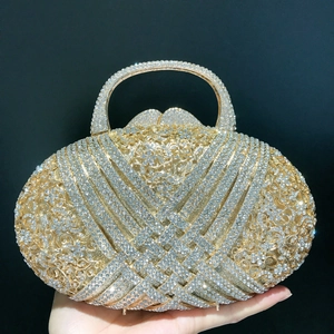 Elegant gold rhinestone evening clutch bag with crystal pavé and hard circular handle