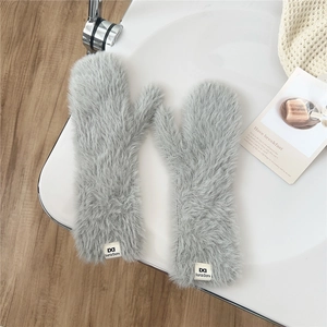 Close-up of thick light gray plush mittens with soft faux fur texture and brand tag