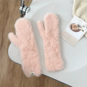 Detail of pink plush mittens showing the soft long-hair texture and brand label