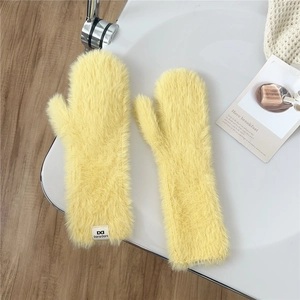 Detail of plush bright yellow mittens showing thick fluffy texture and brand tag label