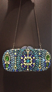 Detailed close-up of a colorful rhinestone floral mandala clutch bag with a silver chain
